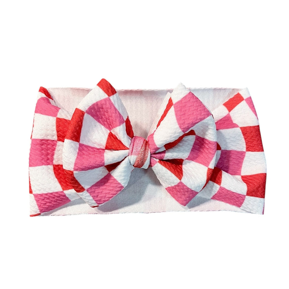 Valentine's Day wavey checker headwrap bow for babies, perfect accessory for hats, socks, and mittens.