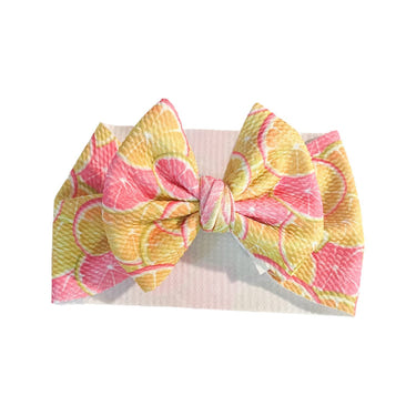 Pink Lemonade Baby Headwrap Bow - Cute and stylish accessory for infants, perfect for hats, socks, and mittens collection.