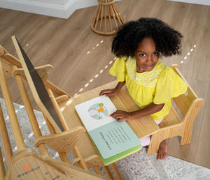 Angle view of Hazel & Olive rocking chair with desk and chair attachment for babies.