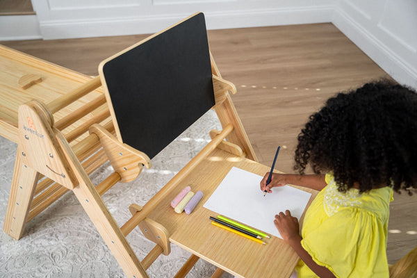 Desk and chair attachment for Hazel & Olive rocking chairs, showcasing a cozy baby-friendly setup.