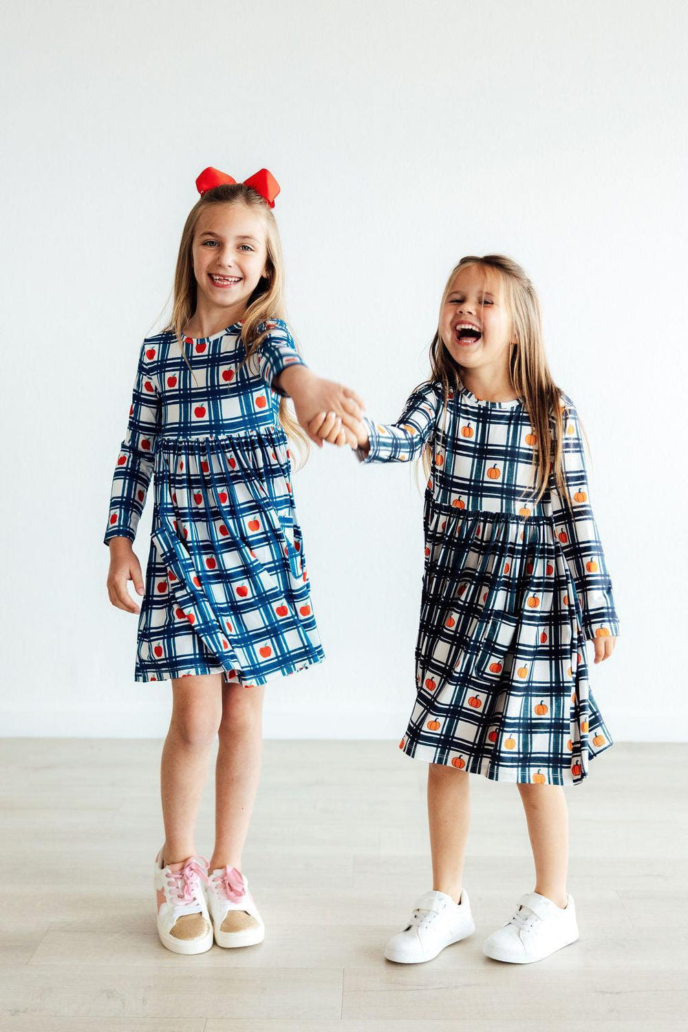 Plaid Pumpkins Long Sleeve Pocket Twirl Dress for babies, perfect for fall fashion and playful twirling.