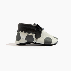 Playmaker Bow Baby Shoe in angle 2, featuring a cute bow design and soft mocc construction for stylish comfort.