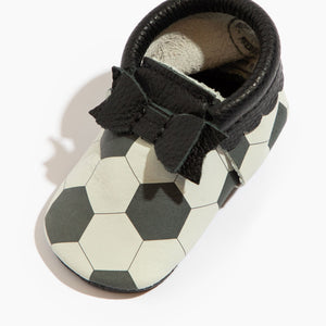 Playmaker Bow Baby Shoe in Angle 3 view, featuring a cute bow design and soft mocc sole for stylish comfort.