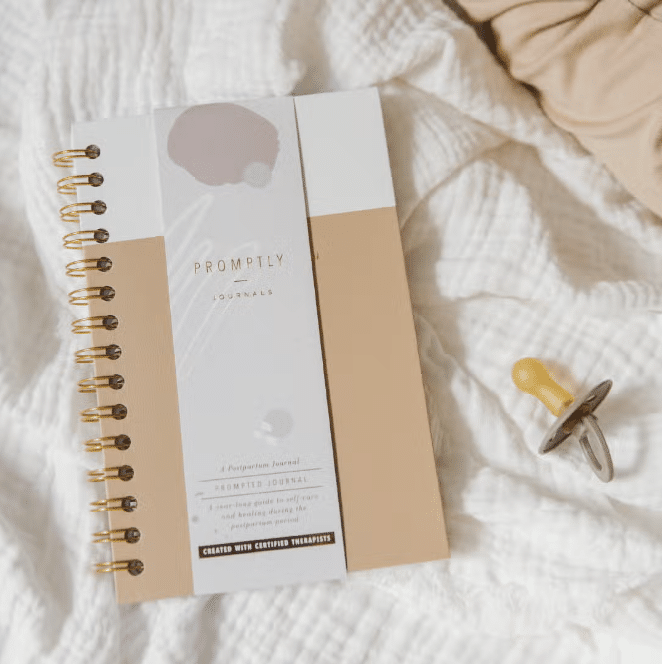 Coil-bound postpartum journal for new mothers, designed for recovery and reflection after childbirth.
