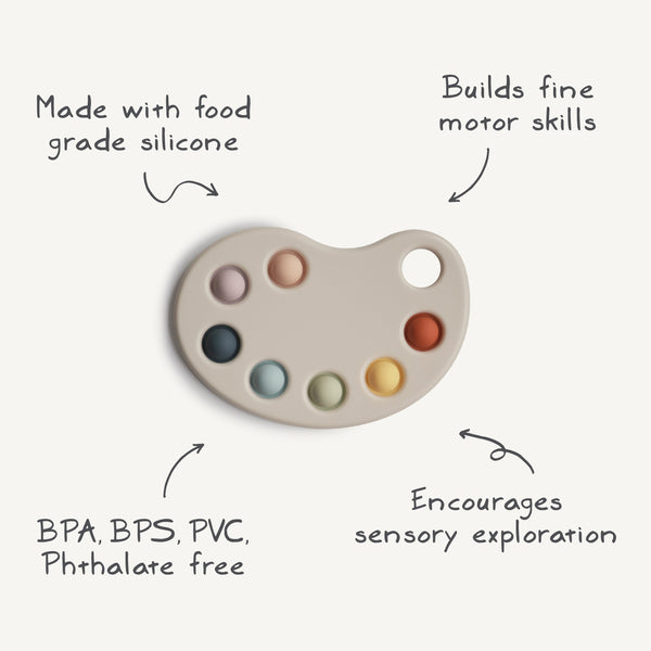 Colorful Paint Palette Press Toy for babies, promoting sensory play and motor skills development. Angle view.
