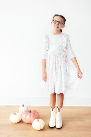Pumpkin Kisses Harvest Wishes 3/4 Sleeve Ruffle Twirl Dress for babies, angle view showcasing playful design and colors.