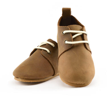 Brown low top oxfords with hard sole for babies, perfect for stylish and comfortable first steps.