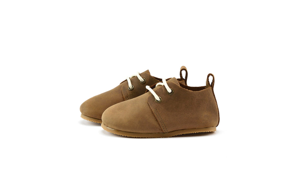 Brown low top oxfords with hard sole for babies, perfect for stylish and comfortable first steps.