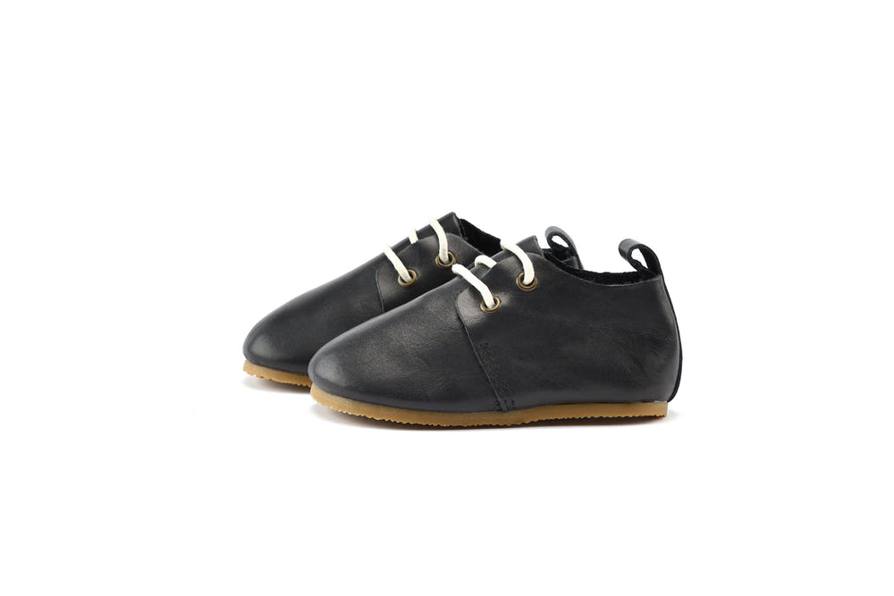 Black low top oxfords with hard sole for babies, stylish and comfortable footwear for little ones.