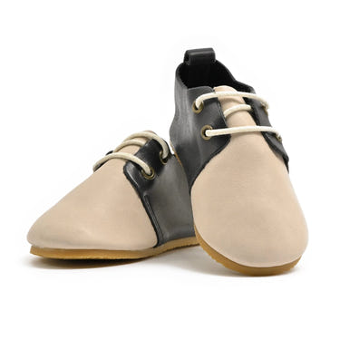 Low top baby oxfords with hard sole in stylish saddle design, perfect for little feet.