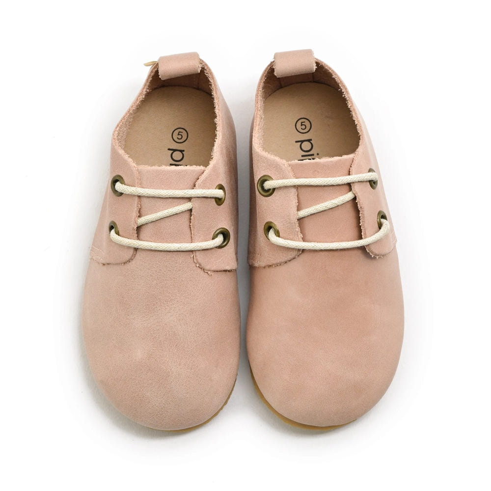 Blush low top oxfords for babies with hard sole, perfect for stylish and comfortable first steps.