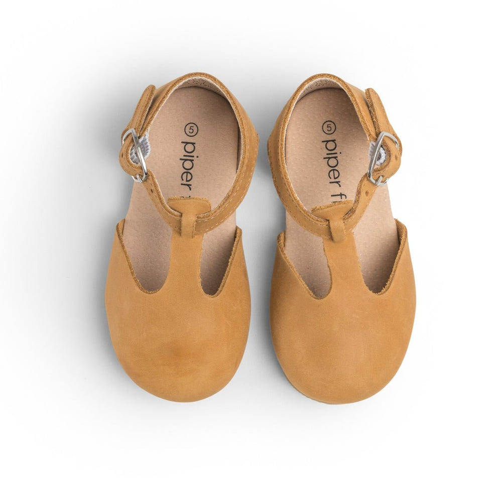 Natural Mary Jane hard sole baby shoes in a stylish design, perfect for little ones' first steps.