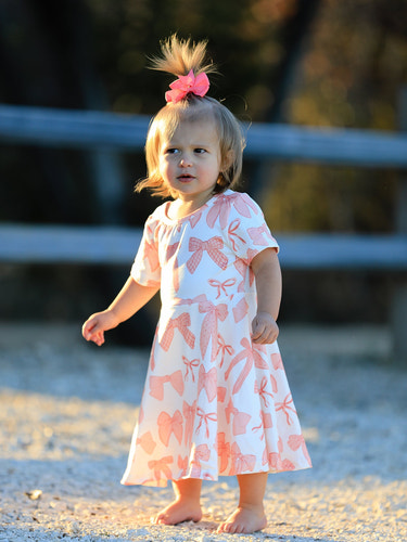 Girls dress with bow print, perfect for stylish and playful outfits. Ideal for special occasions or everyday wear.