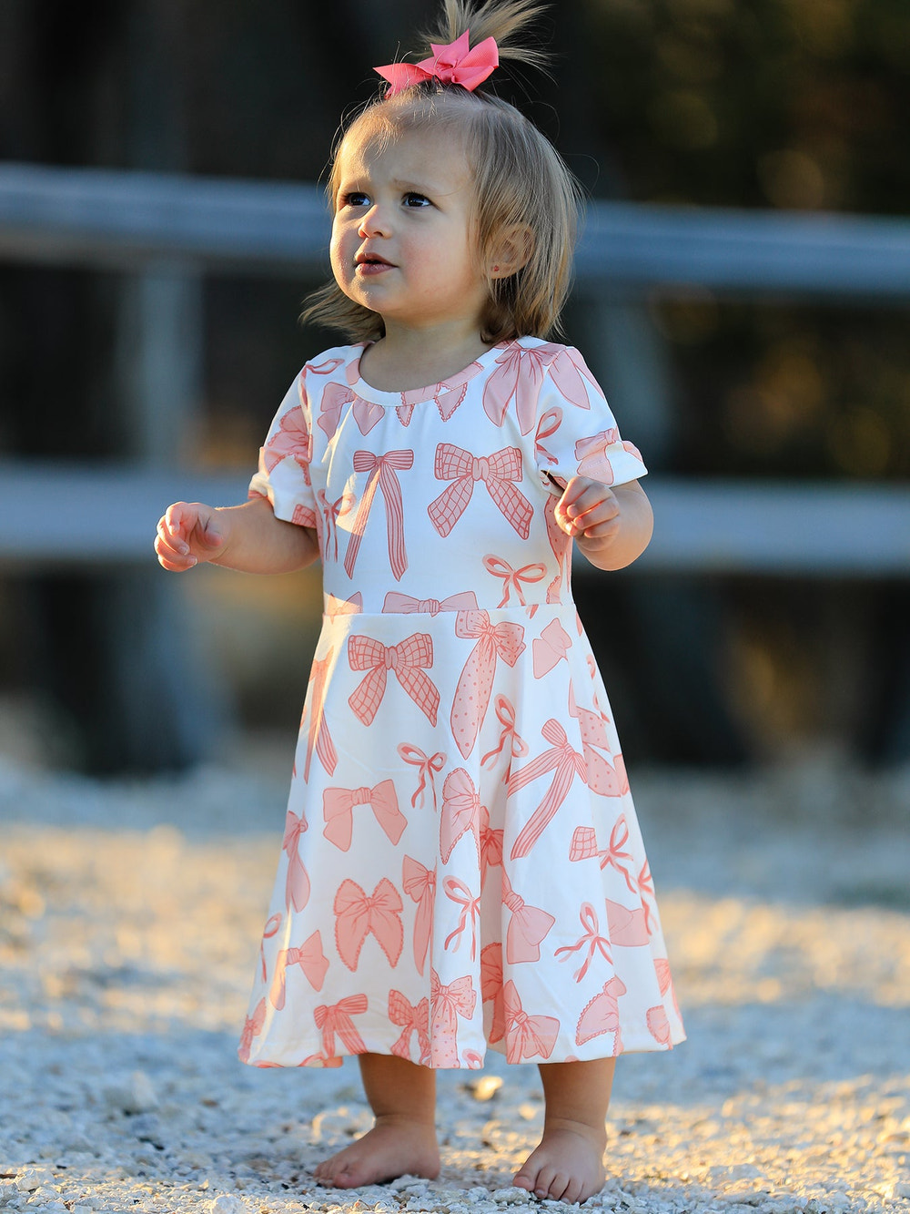 Girls dress with bow print, perfect for stylish and playful outfits. Ideal for special occasions or everyday wear.