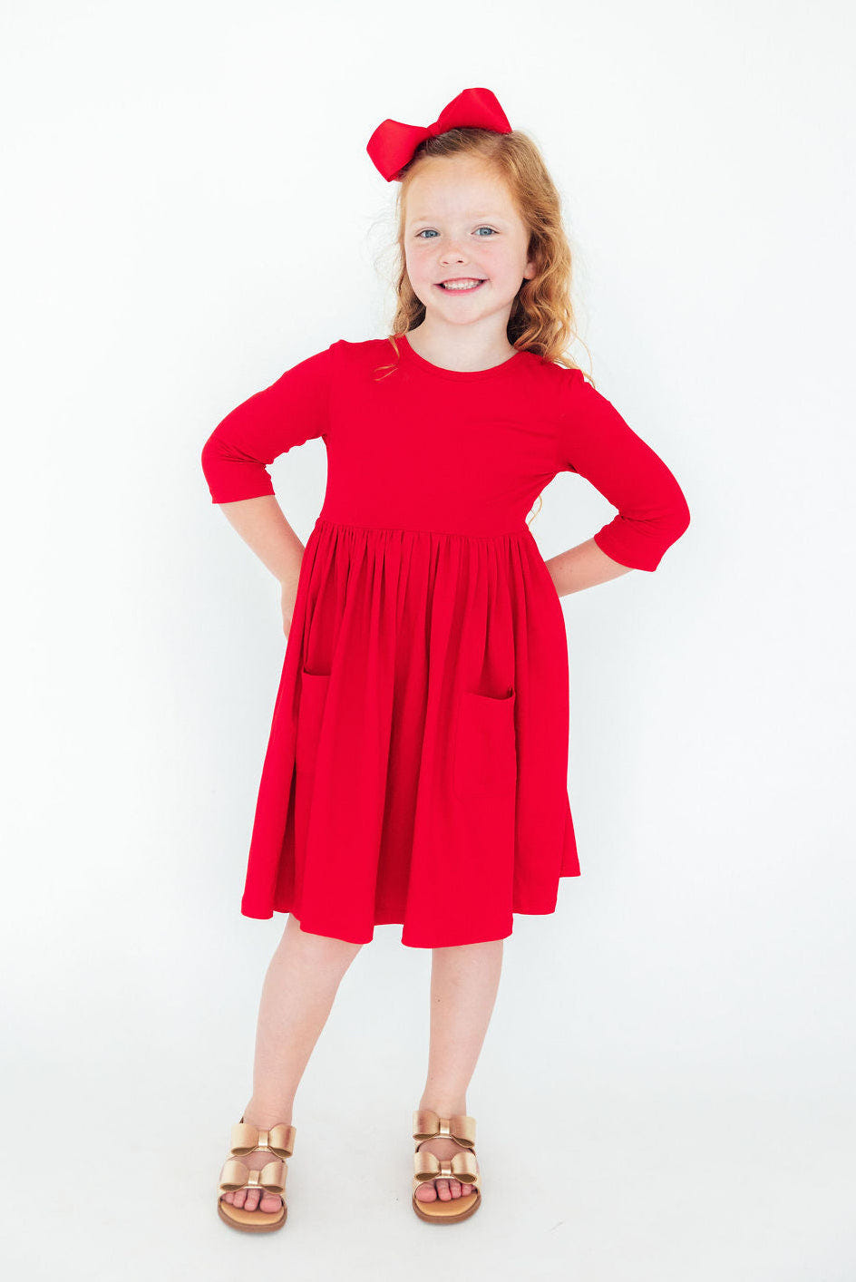 Red 3/4 sleeve twirl dress with pockets for babies, perfect for playful outings and stylish comfort.