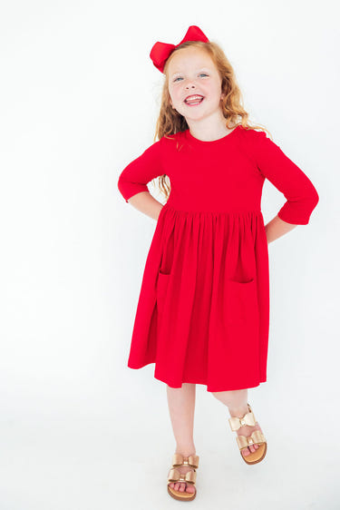 Red 3/4 sleeve twirl dress with pockets for babies, perfect for playful outings and stylish comfort.