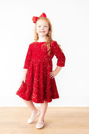 Red velvet sequin dress for babies, angle 3 view showcasing sparkling details and vibrant color.