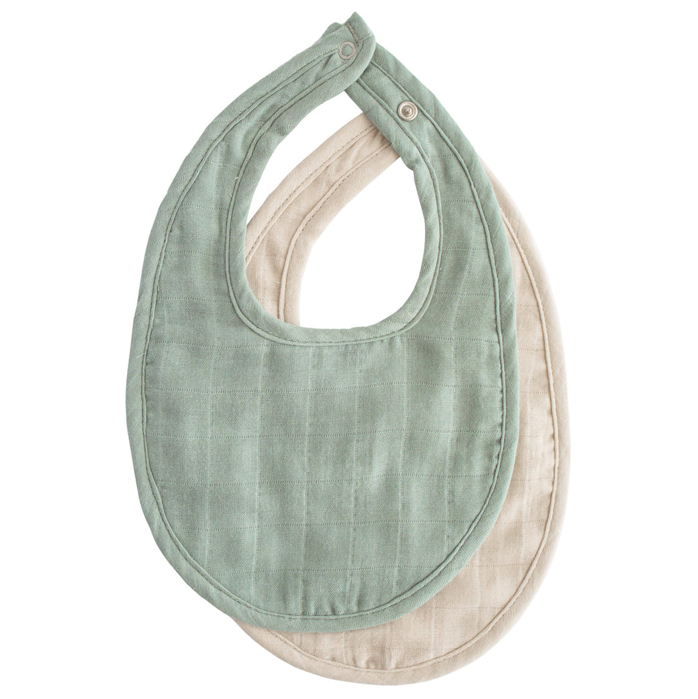 Soft muslin baby bib in pastel colors, perfect for feeding and drooling. Stylish and absorbent for your little one.