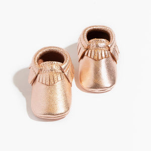 Rose gold moccasin baby shoe, stylish and comfortable footwear for infants. Perfect for any occasion.