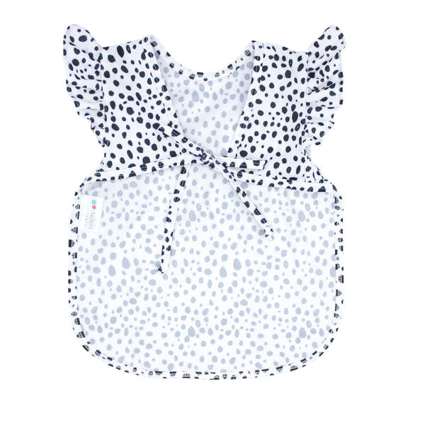 Organic Dot Flutter Bapron for babies, angle view showcasing its cute design and eco-friendly fabric.