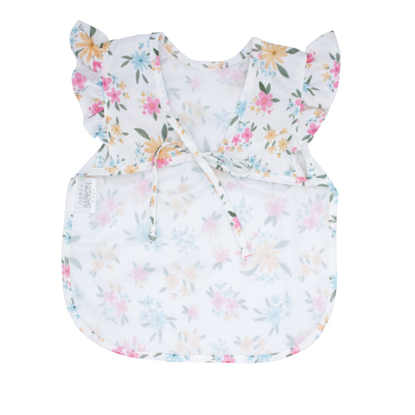 Pastel Floral Flutter Bapron for babies, featuring a charming floral design and flutter sleeves, angle view.