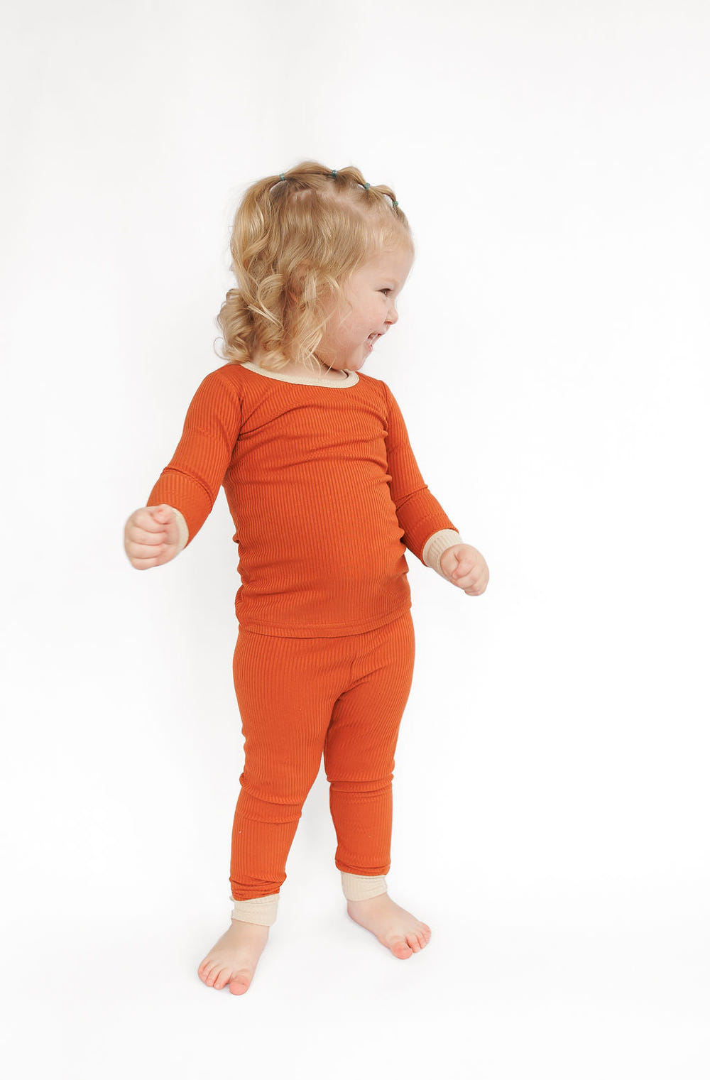 Rust ribbed two-piece set for babies, featuring soft fabric and stylish design, perfect for comfort and play.