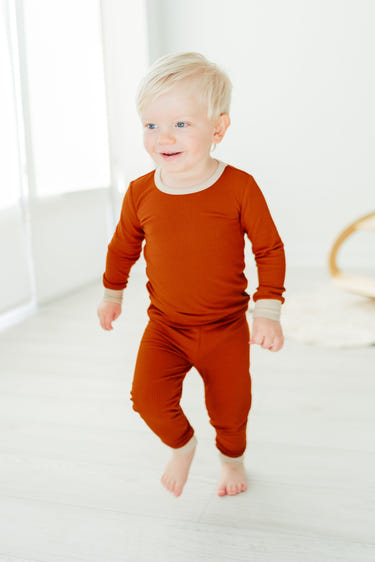 Rust ribbed two-piece set for babies, featuring soft fabric and stylish design, perfect for comfort and play.