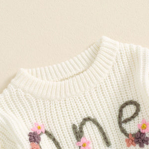 Baby girl birthday sweater with floral embroidery, long sleeve knitted pullover for infants, angle view.