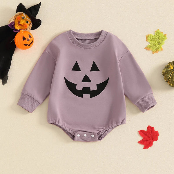 Baby Halloween romper with pumpkin face print, long sleeves, perfect for girls and boys, angle view.
