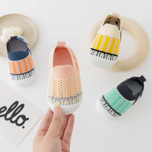 Pink striped baby first walkers, perfect for little feet taking their first steps. Angle view showcasing design and comfort.