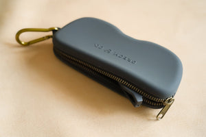 Black Zip + Go Case in soft silicone, perfect accessory for babies, shown from angle 3.