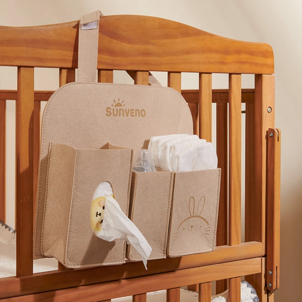 Baby car seat hanging organizer for travel essentials, featuring multiple pockets and a sleek design.