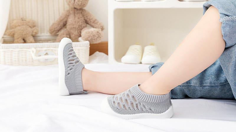 Gray baby first walkers - soft, comfortable shoes for infants taking their first steps.