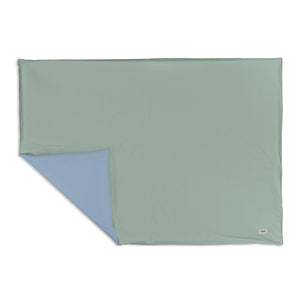 Sage + Breeze Organic Cotton Mat at a 15-degree angle, perfect for safe and stylish playtime for babies.