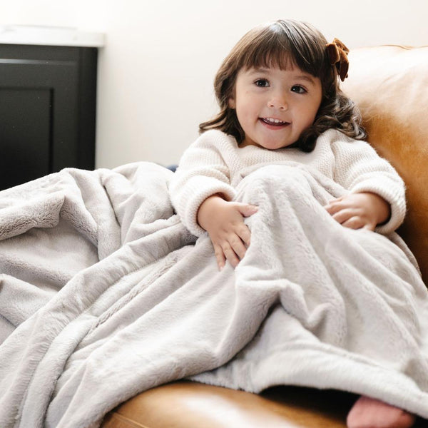 LUSH TODDLER BLANKETS in soft fabric, perfect for cozying up your little one. Angle 2 view showcasing vibrant colors.