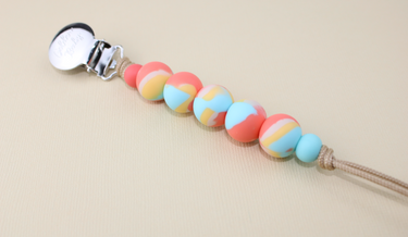 Orange Dream pacifier clip for babies, stylish and functional accessory to keep pacifiers within reach.