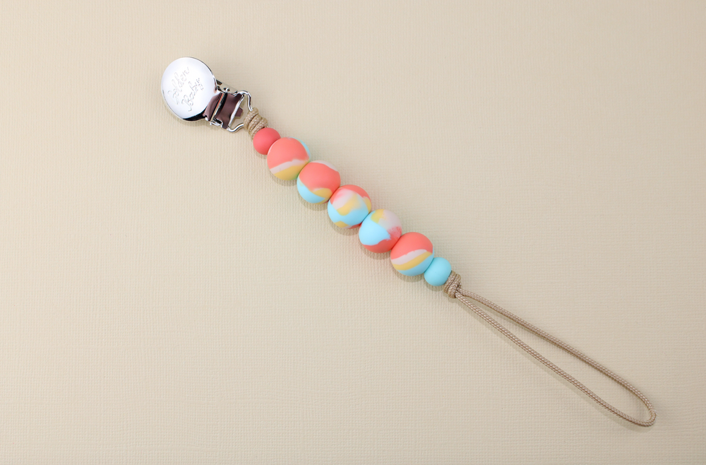 Orange Dream pacifier clip for babies, stylish and functional accessory to keep pacifiers within reach.
