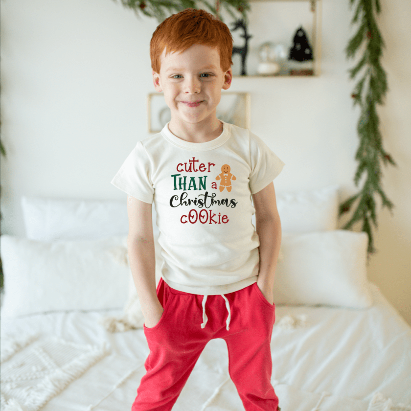 Baby graphic tee featuring a festive Christmas cookie design, perfect for holiday celebrations.