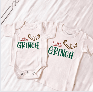 Little Grinch graphic bodysuit for babies, short sleeve, angle view showcasing festive design.