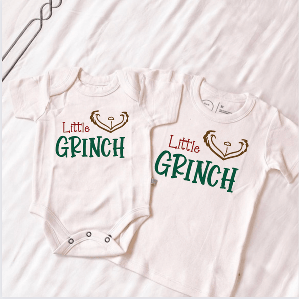 Little Grinch graphic bodysuit for babies, short sleeve, angle view showcasing festive design.