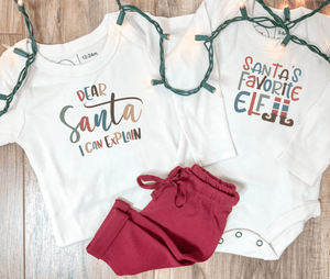 Long sleeve graphic bodysuit for babies, "Santa's Favorite Elf," in a playful design, angle view 3.