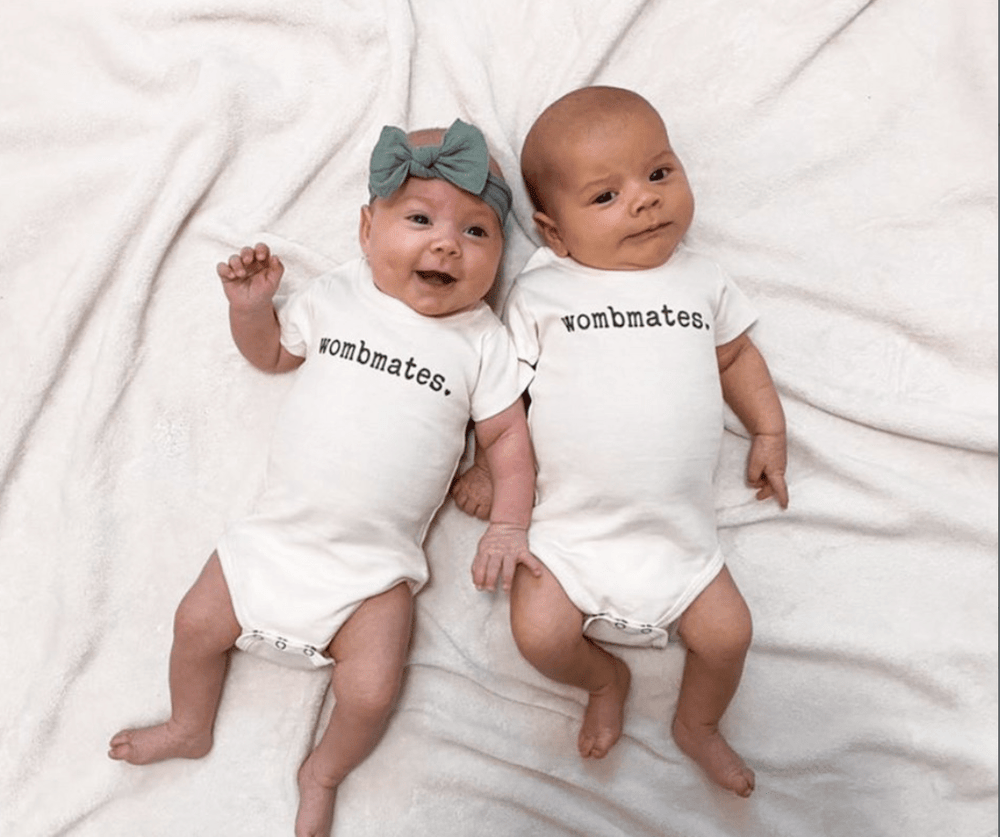 Graphic short sleeve bodysuit for babies by Wombmates, featuring playful designs and soft fabric.