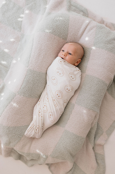 Soft bamboo swaddle blanket by Just Smile, perfect for keeping your baby cozy and comfortable.