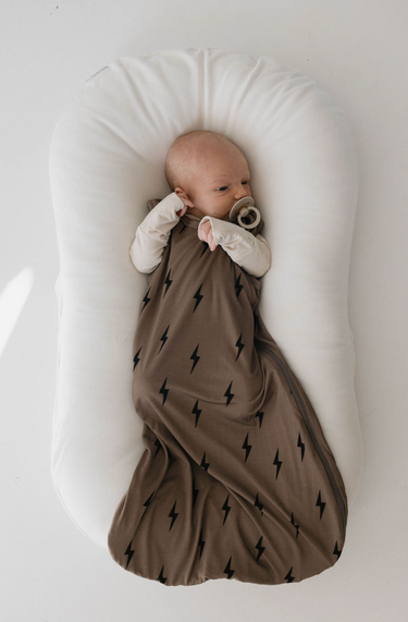 Bamboo sleep sack in brown and black lightning bolt design for swaddling and comfort. Perfect for babies.