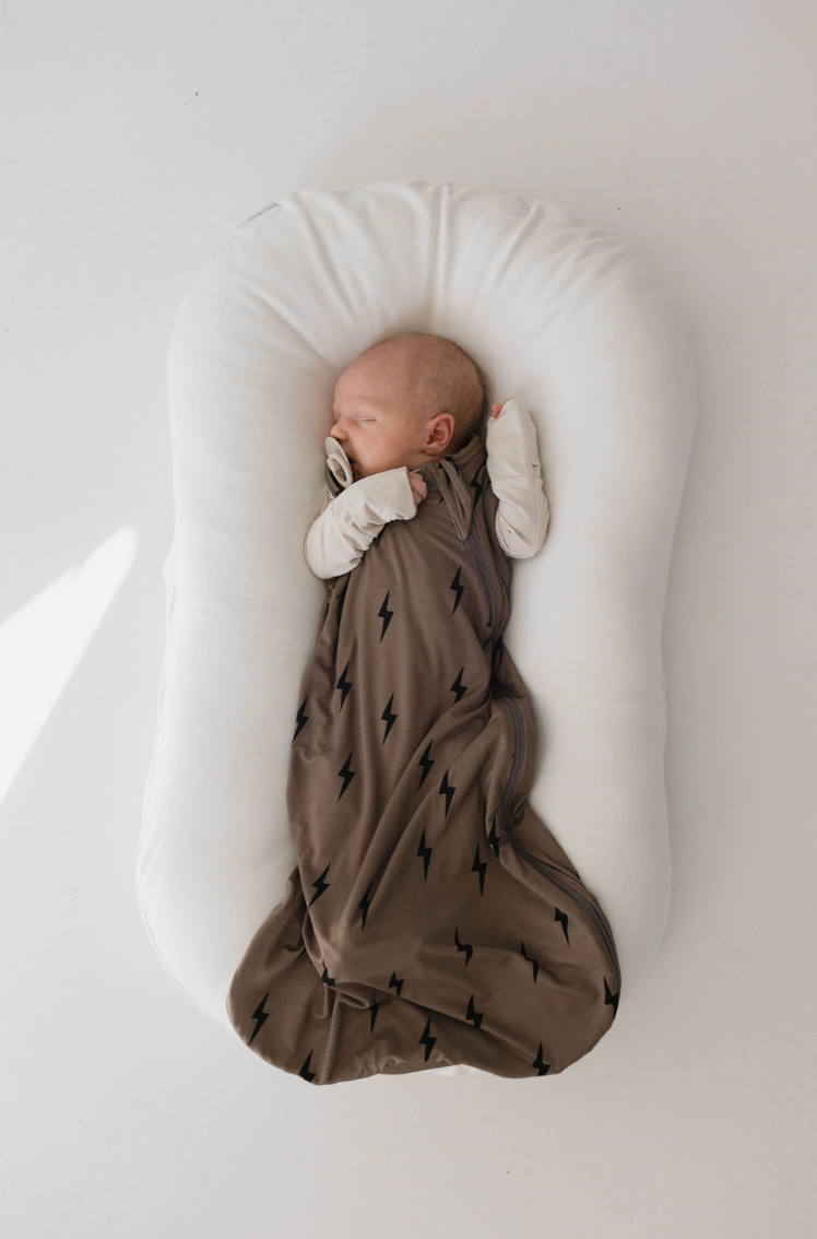 Bamboo sleep sack in brown and black lightning bolt design for swaddling and comfort. Perfect for babies.