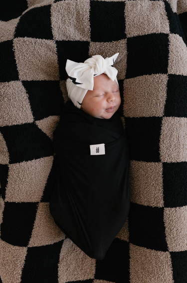 Bamboo swaddle in midnight black, soft and breathable for ultimate comfort. Perfect for wrapping your baby snugly.