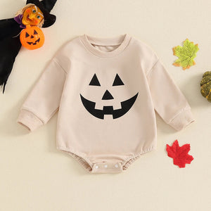 Baby Halloween romper with pumpkin face print, round neck, long sleeves, perfect for girls and boys. Angle view.