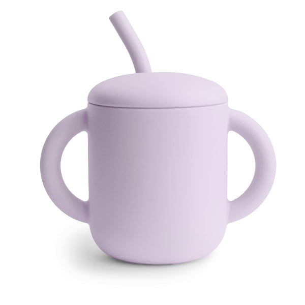 Silicone training cup with straw, angled view, perfect for toddlers learning to drink independently.