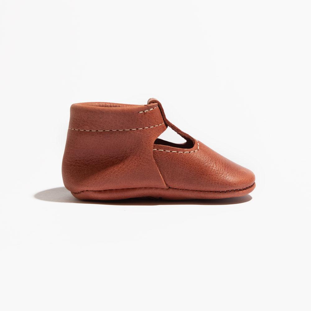 Moab T-Bar Baby Shoe in soft leather, perfect for little feet, featuring a secure strap and stylish design.