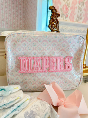 XL Diapers in a clear coat travel bag, angle view showcasing convenience and portability for parents on the go.